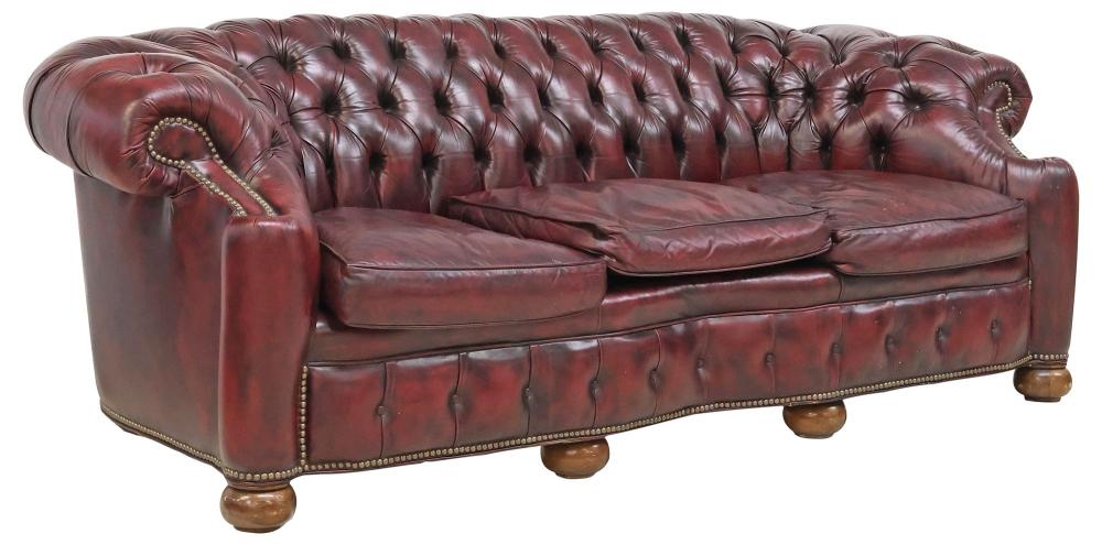 <b>Chesterfield-Style Sofa</b><br> Tufted oxblood leather w/nailhead trim, rolled back & arms<br> approx. 31 tall x 78.5 wide x 37 inches<br> circa 20th cen